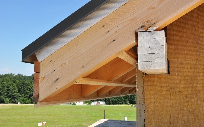 corner side of a residential house with roof overhangs installed